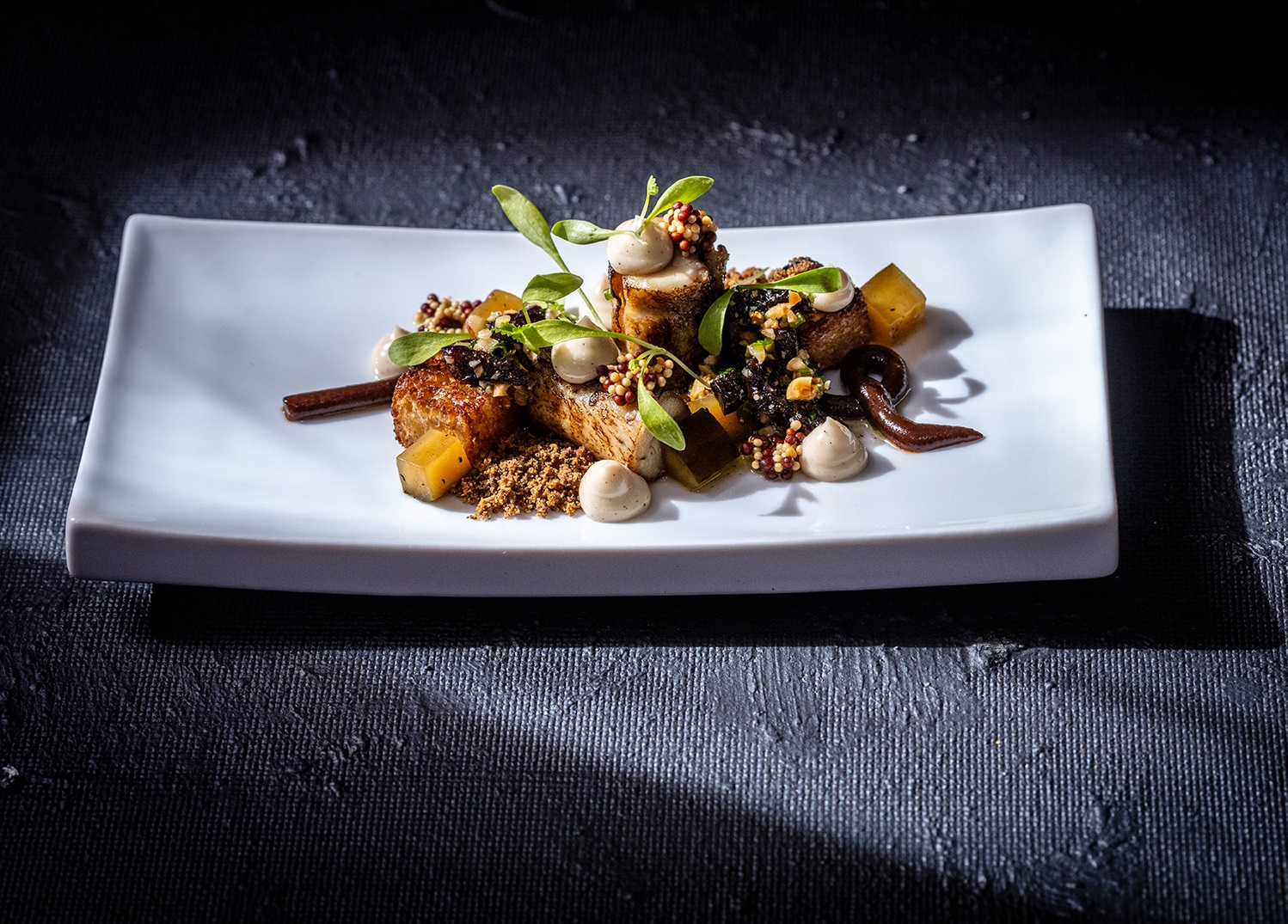 Plated fine dining course at The Happy Uncles